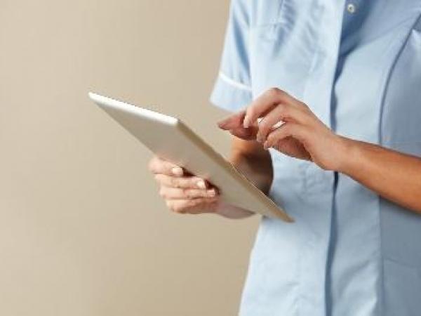 Nurse inputing information into a tablet